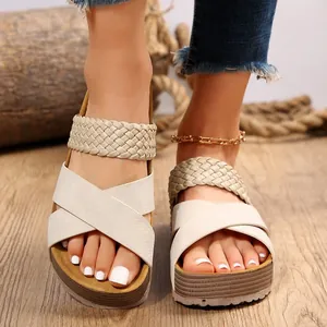 Detail view of women's cream platform sandals with criss-cross and braided straps.