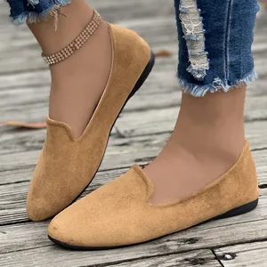 Close-up detail of women's casual camel suede flat loafers with comfortable slip-on design