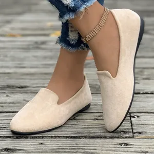 Detailed view of beige suede pointed-toe flat loafers for women with a casual slip-on design