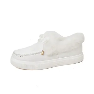 Detailed view of white platform winter shoes with warm faux fur lining and bow detail