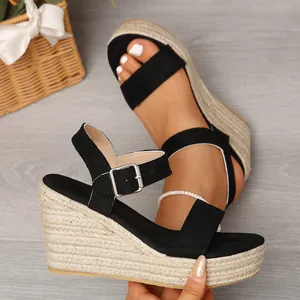 Detailed view of women's black wedge sandals featuring a rustic woven jute platform sole