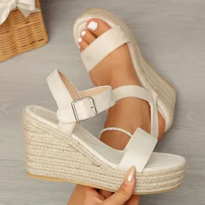 Detail of beige wedge sandals with woven hemp platform and ankle strap
