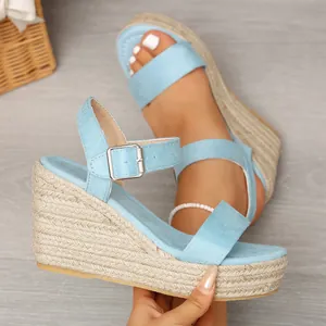 Detail view of light blue suede wedge sandals with stylish braided hemp platform sole