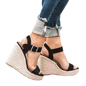 Detail of women's black suede espadrille wedge sandals with buckle ankle strap