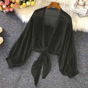 Close-up of black breathable chiffon sun protection shirt with elegant front tie detail