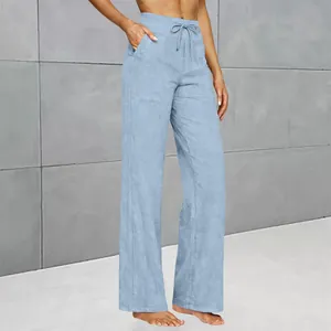 High-waist light blue flare trousers with drawstring waist and functional pockets detail.
