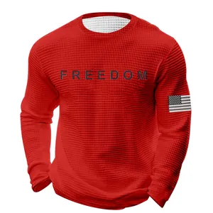 Detail of a men's red waffle knit long sleeve sweatshirt featuring a freedom print