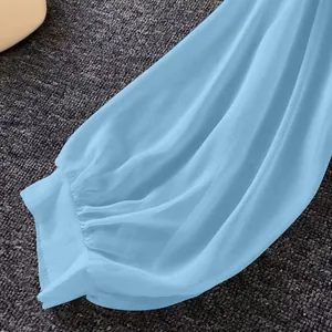 Close-up of light blue chiffon sun protection shirt showing breathable fabric texture