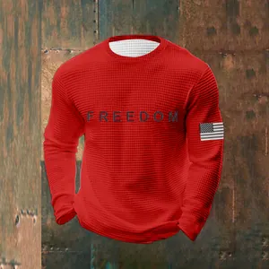 Men's red waffle knit sweatshirt detail showing Freedom print and sleeve flag patch.