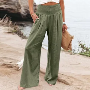 Stylish olive green cotton linen wide leg trousers for women in a casual beach setting