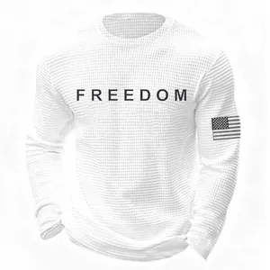 Close-up of white waffle knit sweatshirt featuring black FREEDOM print on chest