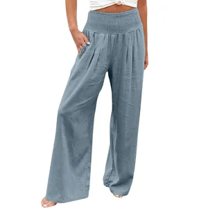 Detail view of casual blue cotton linen wide-leg pants for women with smocked waist.