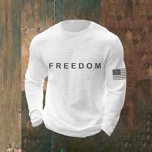 Close-up detail of a white waffle knit crew neck sweatshirt with Freedom text print