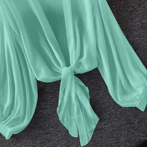 Detail of breathable mint green chiffon sun protection blouse with stylish front tie-knot