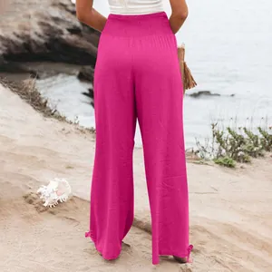 Vista posteriore di pantaloni larghi magenta con vita alta elastica e fiocchi laterali