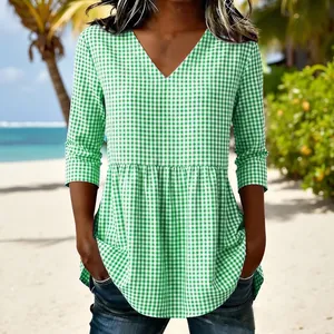 Detailed view of a casual women's V-neck green gingham plaid top with a stylish peplum hem