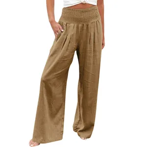 Detailed view of khaki linen wide-leg pants featuring a smocked elastic high waist