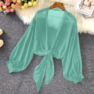 Detailed view of mint green sheer chiffon sunscreen shirt with tie-knot and puff sleeves.