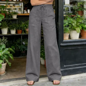 Close-up detail of grey high-waist wide-leg casual pants with drawstring and patch pockets