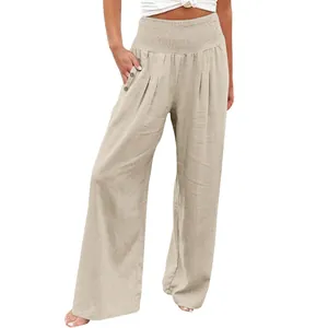 Detail of women's wide-leg linen trousers with smocked high waist and button pockets