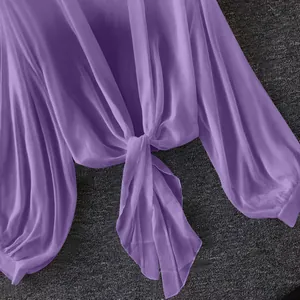 Close-up of purple chiffon blouse with front-tie knot and sheer breathable fabric.