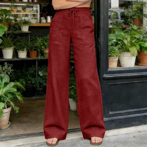 Detail showing high-waisted maroon wide-leg pants with drawstring and pockets