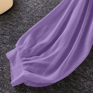 Close-up of purple chiffon sleeve with elastic cuff and sheer fabric texture