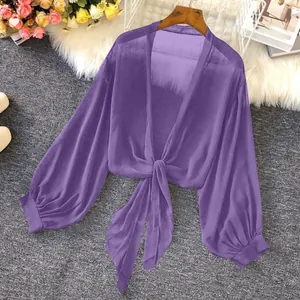 Detail of purple sheer chiffon sun protection top with tie-knot and lantern sleeves