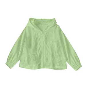 Close-up of light green jacquard sun protection jacket with textured fabric detail