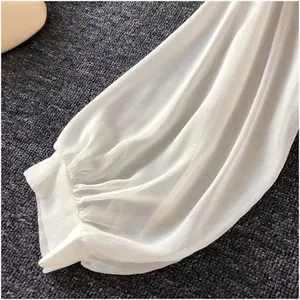Detailed close-up of a breathable white chiffon blouse sleeve with elastic cuff