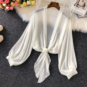 Detailed view of white breathable chiffon sun protection shirt with front tie knot