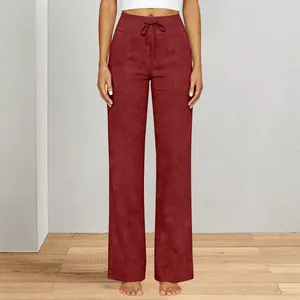 Close-up view of high-waisted burgundy wide leg yoga pants with front pockets and drawstring