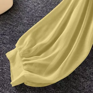 Macro view of light yellow breathable chiffon blouse sleeve with elastic cuff