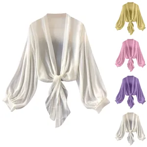 Close-up view of chiffon sun-protection shrug showing multiple color variants available