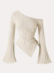 Close-up view of elegant one-shoulder rib-knit top with asymmetrical hem and bell sleeves