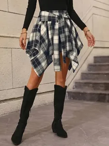 Detail view of fashion asymmetric navy plaid skirt with tie-waist and irregular hemline