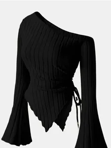 Detail view of black asymmetric one-shoulder top with bell sleeves and ribbed texture.