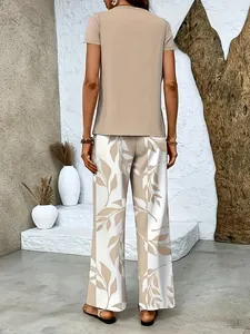 Back view of elegant beige short sleeve top and leaf print wide leg trousers set