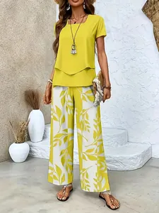 Full-body shot of a yellow short-sleeved top and leafy print wide-leg pants summer set