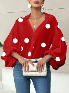 Detail view of red women's blouse featuring white polka dots and puff long sleeves