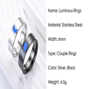 Detail of luminous sun and moon stainless steel couple rings with "I love you" engraving.