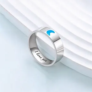Macro detail of 'I love you' engraving inside a stainless steel moon ring with blue inlay