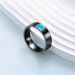 Detailed macro view of black luminous stainless steel couple ring with I love you engraving