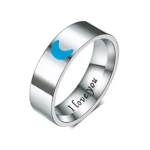 Close-up of stainless steel ring featuring "I love You" engraving and blue moon design