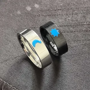 Close-up of sun and moon stainless steel couple rings with I love you engraving