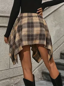 Close-up detail view of an asymmetrical plaid skirt with a stylish and irregular hemline design