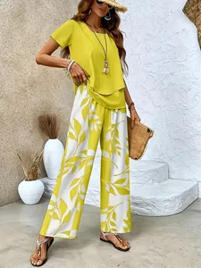Summer two-piece set featuring yellow short sleeve top and floral print wide-leg pants