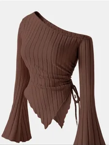 Detailed view of brown one-shoulder ribbed top with asymmetrical hem and bell sleeves.