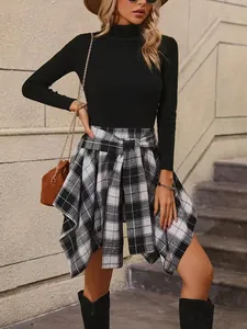 Close-up view of the irregular plaid tie-waist skirt with stylish asymmetric hemline