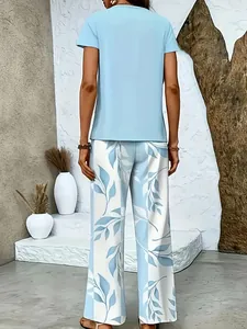 Rear view of a light blue short sleeve top and floral print wide-leg trousers set for women